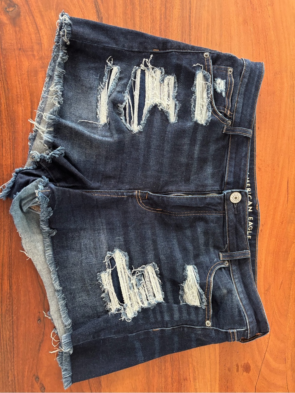 American Eagle high rise shortie distressed denim shorts. Dark blue. Size 16.